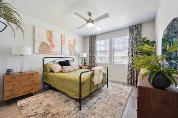 a bedroom with a bed and a ceiling fan